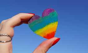 photo of person holding multicolored heart decor
